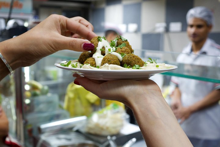 Savor the delightful flavors of the Middle East as you enjoy fresh falafels served with creamy sauces surrounded by the lively hustle of Old Dubai’s culinary scene.